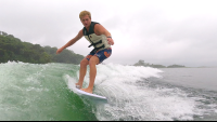 a man wakesurfs on lake arenal in the morning
 - Costa Rica