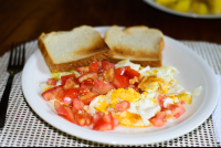 Scrambled Eggs Topped With Fresh Tomatoe Served With A Toast
 - Costa Rica