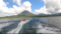 a couple of friends tubing on lake arenal with the view of the volcano
 - Costa Rica