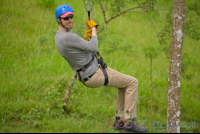 Man Riding A Cable On Blue River Zipline Rincon De La Vieja
 - Costa Rica